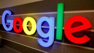 FILE PHOTO: An illuminated Google logo is seen inside an