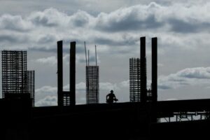 FILE PHOTO: Construction worker silhouetted during morning light