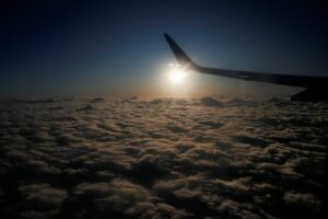 FILE PHOTO: The sun rises behind the wing of a