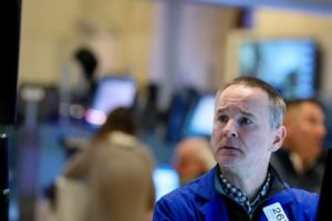 FILE PHOTO: Traders work on the floor of the NYSE