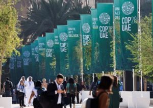Delegates walk at the United Nations Climate Change Conference COP28